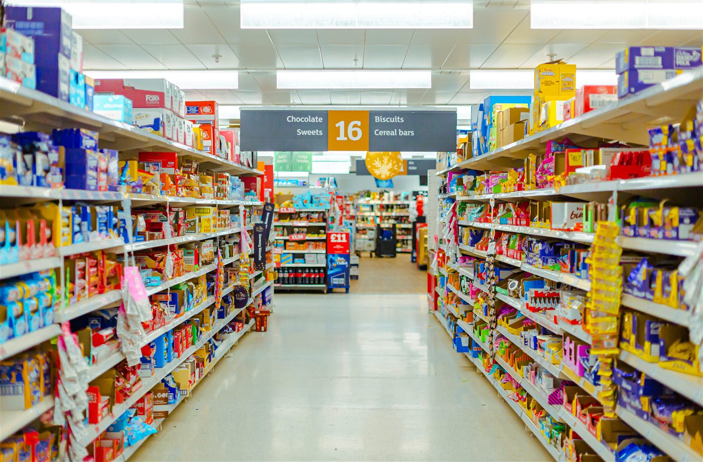 Supermarket aisle stocked with FMCG products